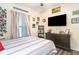 Comfortable bedroom featuring a large dresser with a TV and rustic wood accents, perfect for relaxation at 101 Maddington Place Dr. # 103, Surfside Beach, SC 29575