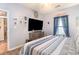 Bright bedroom featuring a large TV on a dresser, creating a comfortable and functional living space at 101 Maddington Place Dr. # 103, Surfside Beach, SC 29575