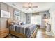 Cozy bedroom with wood-look floors, a ceiling fan, and coastal-themed decor at 101 Maddington Place Dr. # 103, Surfside Beach, SC 29575