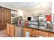 Spacious kitchen showcases stainless steel appliances, granite counters, and a farmhouse-style aesthetic at 101 Maddington Place Dr. # 103, Surfside Beach, SC 29575