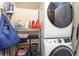 Bright laundry room with stackable washer and dryer and overhead shelving with useful supplies at 101 Maddington Place Dr. # 103, Surfside Beach, SC 29575