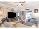 Bright living room with a modern TV stand and access to the outdoor patio at 101 Maddington Place Dr. # 103, Surfside Beach, SC 29575