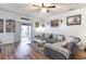 Spacious living room with a large sectional sofa and a sliding door to the patio at 101 Maddington Place Dr. # 103, Surfside Beach, SC 29575