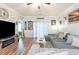 Cozy living room with a large sectional sofa and a decorative 'Beach House' sign at 101 Maddington Place Dr. # 103, Surfside Beach, SC 29575