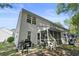 Exterior view of a home with a screened-in porch, patio, and well-maintained lawn at 1064 Penny Ln. # 1064, Myrtle Beach, SC 29577