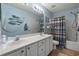 Charming bathroom with a double sink vanity, light blue walls, and decorative fish netting at 1064 Penny Ln. # 1064, Myrtle Beach, SC 29577