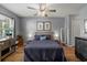 Comfortable bedroom with a ceiling fan, hardwood floors, and ample natural light from the window at 1064 Penny Ln. # 1064, Myrtle Beach, SC 29577
