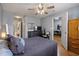 Spacious bedroom with hardwood floors, ceiling fan, and a view into the connected living room and bathroom at 1064 Penny Ln. # 1064, Myrtle Beach, SC 29577