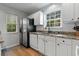 Updated kitchen with stainless steel refrigerator and a bright window overlooking the yard at 1064 Penny Ln. # 1064, Myrtle Beach, SC 29577