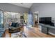 Bright living room featuring a large window, stylish furniture, and hardwood floors at 1064 Penny Ln. # 1064, Myrtle Beach, SC 29577