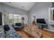 Bright living room featuring a large window, stylish furniture, and hardwood floors at 1064 Penny Ln. # 1064, Myrtle Beach, SC 29577