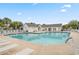 Large community pool with lounge chairs, a bath house, and manicured landscaping at 1064 Penny Ln. # 1064, Myrtle Beach, SC 29577