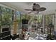 Enclosed porch with ceiling fan, a view of the wooded backyard, and plenty of room for seating at 1064 Penny Ln. # 1064, Myrtle Beach, SC 29577