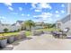 Backyard patio featuring a retaining wall, chairs, and a well-manicured lawn at 1239 Pyxie Moss Dr., Little River, SC 29566