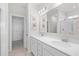 Bathroom featuring dual sinks, large mirror, and a walk-in closet at 1239 Pyxie Moss Dr., Little River, SC 29566