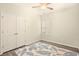 Bedroom showcasing hardwood floors, shuttered window, spacious closet, and bright ceiling fan at 1239 Pyxie Moss Dr., Little River, SC 29566