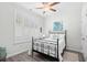 Cozy bedroom featuring shuttered windows, ceiling fan, and a comfortable iron frame bed at 1239 Pyxie Moss Dr., Little River, SC 29566
