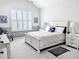 Bright bedroom features a large bed, white furniture and shuttered windows for natural light at 1239 Pyxie Moss Dr., Little River, SC 29566