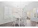 Bright dining area featuring a modern chandelier, vaulted ceilings, and large windows with backyard views at 1239 Pyxie Moss Dr., Little River, SC 29566