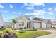 Attractive single-story home featuring stone accents, a well-kept lawn, and an attached one-car garage at 1239 Pyxie Moss Dr., Little River, SC 29566