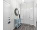 Inviting foyer with white walls, wood-look floors, a decorative mirror, and a console table at 1239 Pyxie Moss Dr., Little River, SC 29566