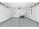 Spacious two car garage featuring a clean epoxy floor, a storage chest and newly painted walls at 1239 Pyxie Moss Dr., Little River, SC 29566
