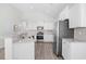 Spacious kitchen with white cabinets, granite countertops, stainless appliances, and open layout to the living area at 1239 Pyxie Moss Dr., Little River, SC 29566