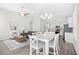 Open concept living and dining area featuring high ceilings, stylish decor, and abundant natural light at 1239 Pyxie Moss Dr., Little River, SC 29566