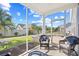 Screened porch with comfortable seating offers a cozy outdoor retreat overlooking a well-kept yard at 1239 Pyxie Moss Dr., Little River, SC 29566