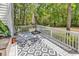 Private deck with white railings, outdoor seating area, umbrella stand and surrounded by lush greenery at 157 Egret Run Ln. # 514, Pawleys Island, SC 29585