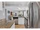 Open-concept kitchen with granite counters, stainless appliances, seamless transition to living area, and natural light at 157 Egret Run Ln. # 514, Pawleys Island, SC 29585