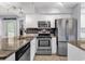 Modern kitchen featuring stainless steel appliances, granite countertops, white cabinets, and sleek backsplash at 157 Egret Run Ln. # 514, Pawleys Island, SC 29585