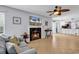 Cozy living room features fireplace, tile flooring, ceiling fan, and seamless access to the kitchen at 157 Egret Run Ln. # 514, Pawleys Island, SC 29585