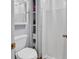 Compact bathroom with a white toilet, shower, and convenient built-in shelves for storage at 157 Egret Run Ln. # 514, Pawleys Island, SC 29585