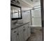 Bathroom featuring a granite vanity, mirror, toilet, and tiled stand up shower with glass doors at 161 Penn Circle, Galivants Ferry, SC 29544