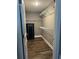 Walk-in closet featuring wood look floors, ventilated shelving, and a Field & Stream safe for valuables at 161 Penn Circle, Galivants Ferry, SC 29544