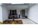Inviting front porch with seating, flowers, and an Easter decoration on the front door at 161 Penn Circle, Galivants Ferry, SC 29544