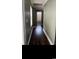 Hallway featuring dark hardwood floors, fresh paint, and natural light from nearby windows at 161 Penn Circle, Galivants Ferry, SC 29544