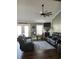 Spacious living room with recliner sofas, ceiling fan, fireplace, and bright natural light at 161 Penn Circle, Galivants Ferry, SC 29544