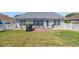 Backyard with a patio, green lawn, and a privacy fence at 174 Seville Dr., Murrells Inlet, SC 29576