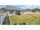 Backyard with a patio, green lawn, and a privacy fence at 174 Seville Dr., Murrells Inlet, SC 29576