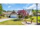 Lovely landscaped yard with green grass, shrubbery, and a bright red Japanese maple tree at 174 Seville Dr., Murrells Inlet, SC 29576