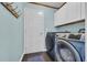 Convenient laundry room equipped with a washer, dryer, cabinets, and hanging rack at 174 Seville Dr., Murrells Inlet, SC 29576