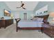 Cozy main bedroom with a mounted TV, ceiling fan, and ample natural light at 174 Seville Dr., Murrells Inlet, SC 29576