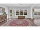 Well-lit sitting room featuring hardwood floors, large windows, and white trim at 174 Seville Dr., Murrells Inlet, SC 29576