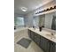 Bathroom featuring a double vanity, large mirror, bathtub and shower combination at 19 Pistachio Loop # G, Murrells Inlet, SC 29576