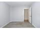 Neutral bedroom with wood-look floors and a view into another room at 19 Pistachio Loop # G, Murrells Inlet, SC 29576