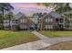 Beautiful two-story condo with well-manicured lawn, brick facade, and inviting walkway at 19 Pistachio Loop # G, Murrells Inlet, SC 29576