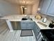 Spacious kitchen featuring stainless steel dishwasher and sink and countertops with breakfast bar at 19 Pistachio Loop # G, Murrells Inlet, SC 29576