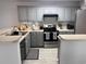 Clean kitchen featuring gray cabinets, stainless steel appliances, and modern countertops at 19 Pistachio Loop # G, Murrells Inlet, SC 29576